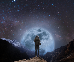 A hiker looking at a full moon
