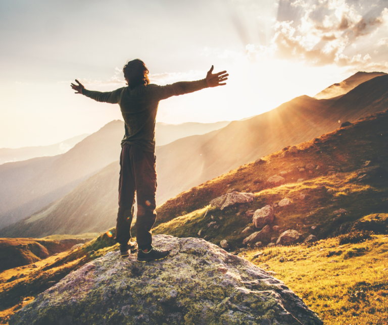 A man with his arms open looking at the sky